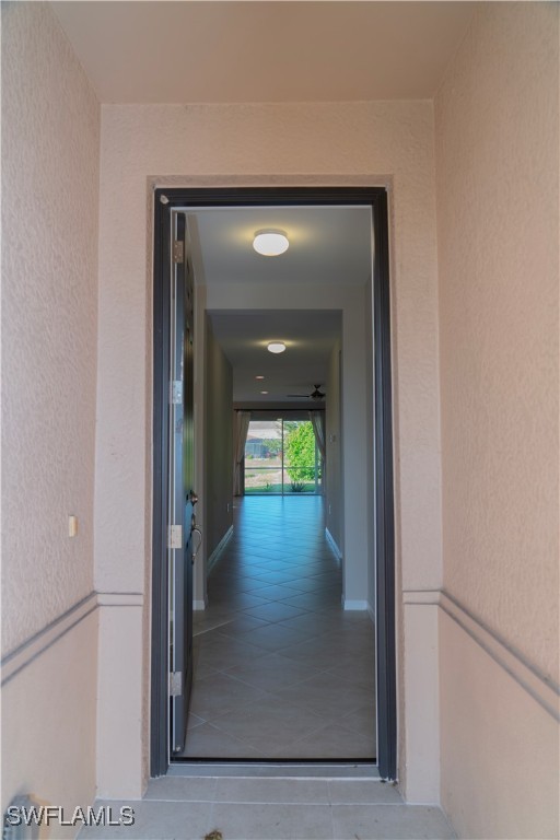 a view of a hallway view with wooden floor and a glass door