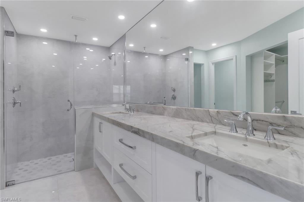 a bathroom with a double vanity sink and a mirror