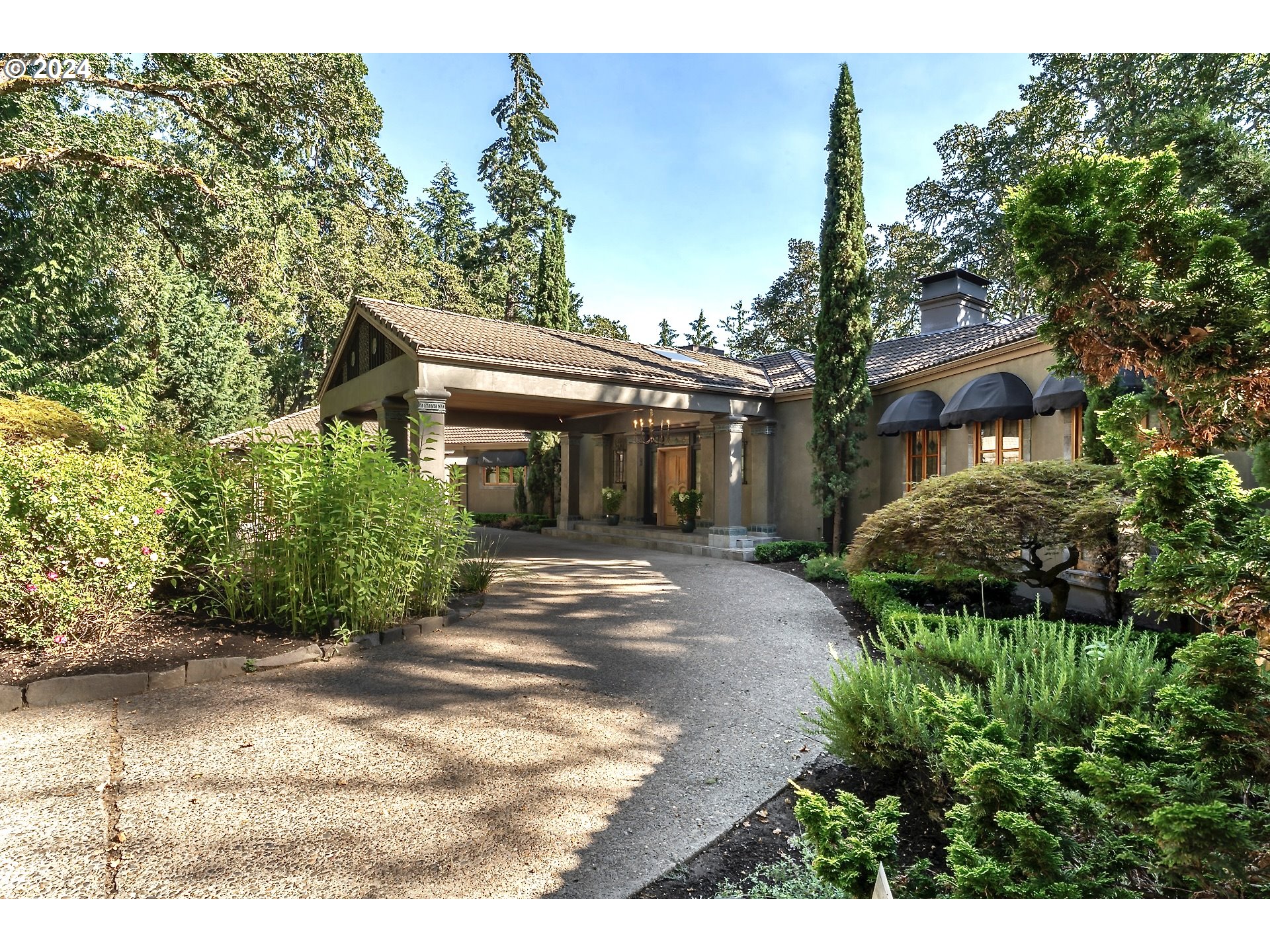 a front view of a house with a garden