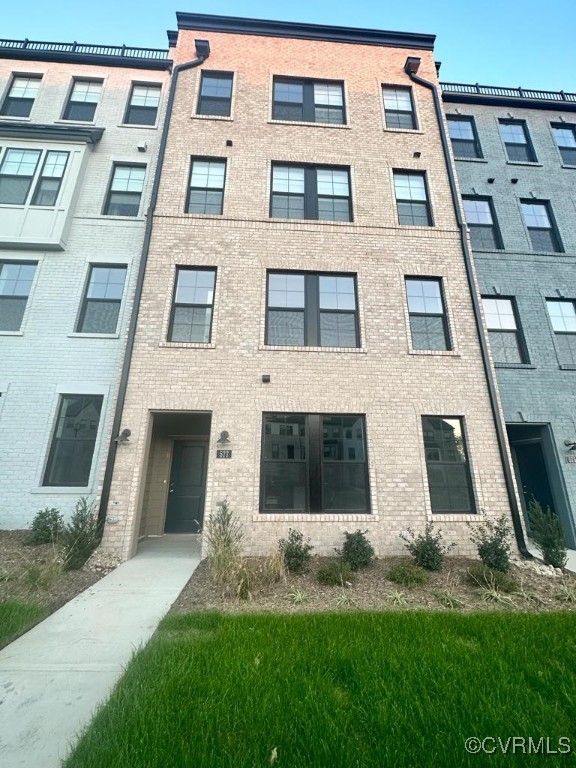 a view of a brick building next to a yard