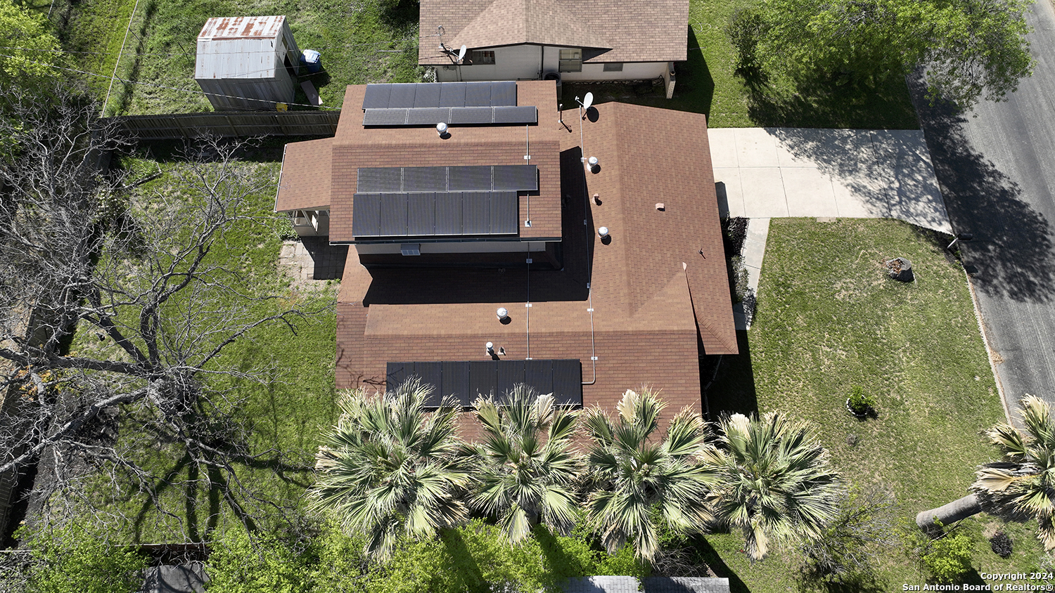 an aerial view of a house with a yard