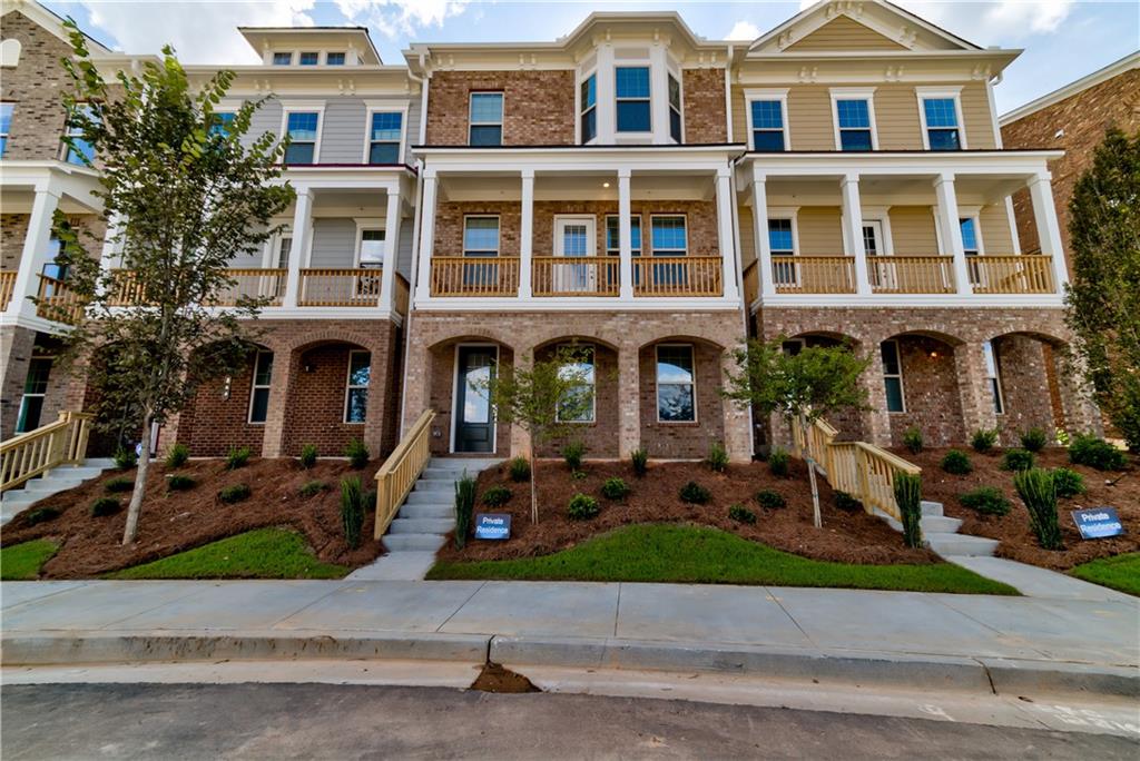 front view of a brick house with a yard