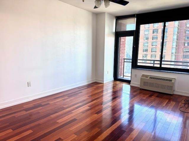 a view of room with window and wooden floor