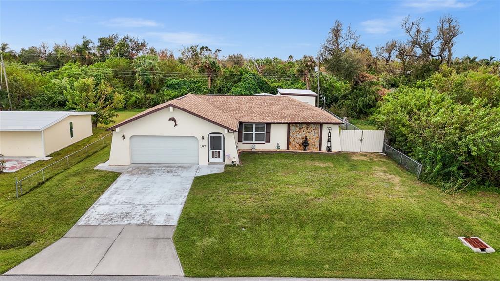 a aerial view of a house with a yard and trees