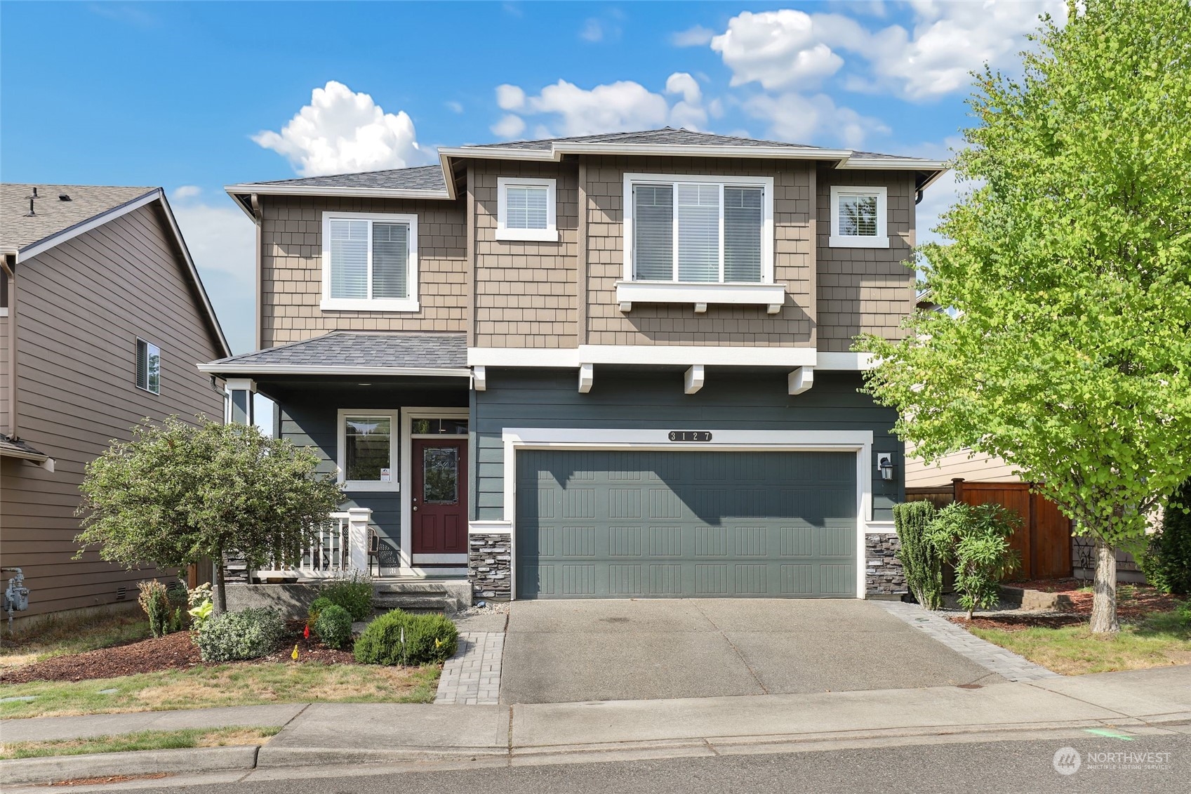 a front view of a house with garage