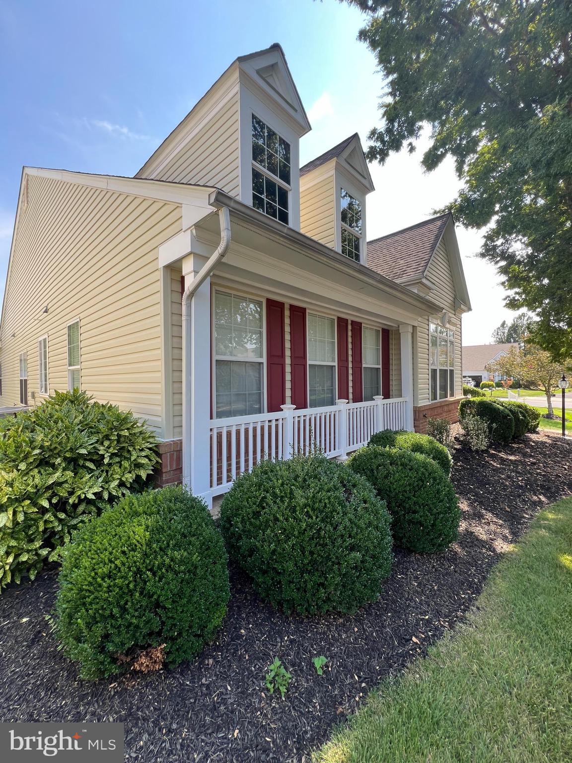 a view of a house with a yard and plants