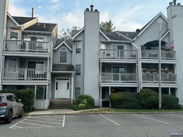 a front view of a residential apartment building with a yard