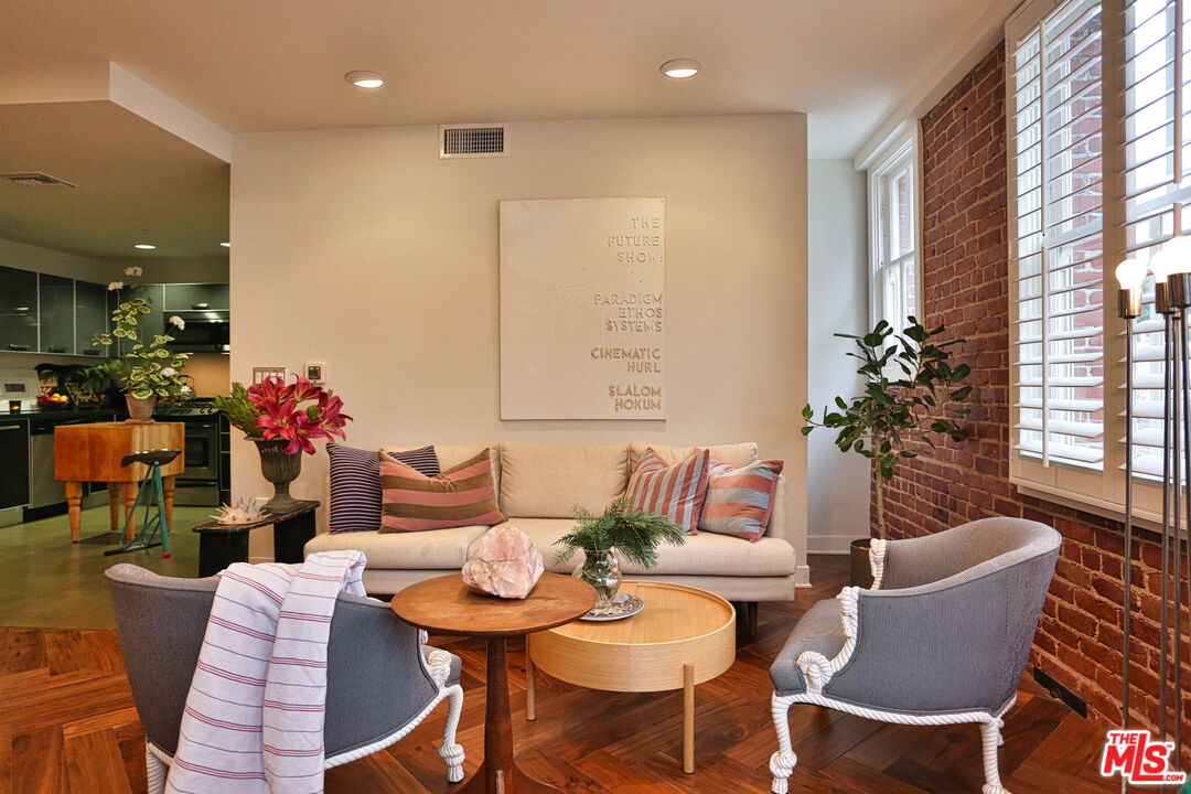 a dining room with furniture and wooden floor