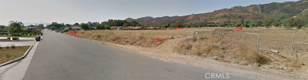 a view of a road with trees in the background