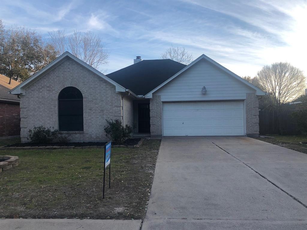 a view of a house with a yard and garage