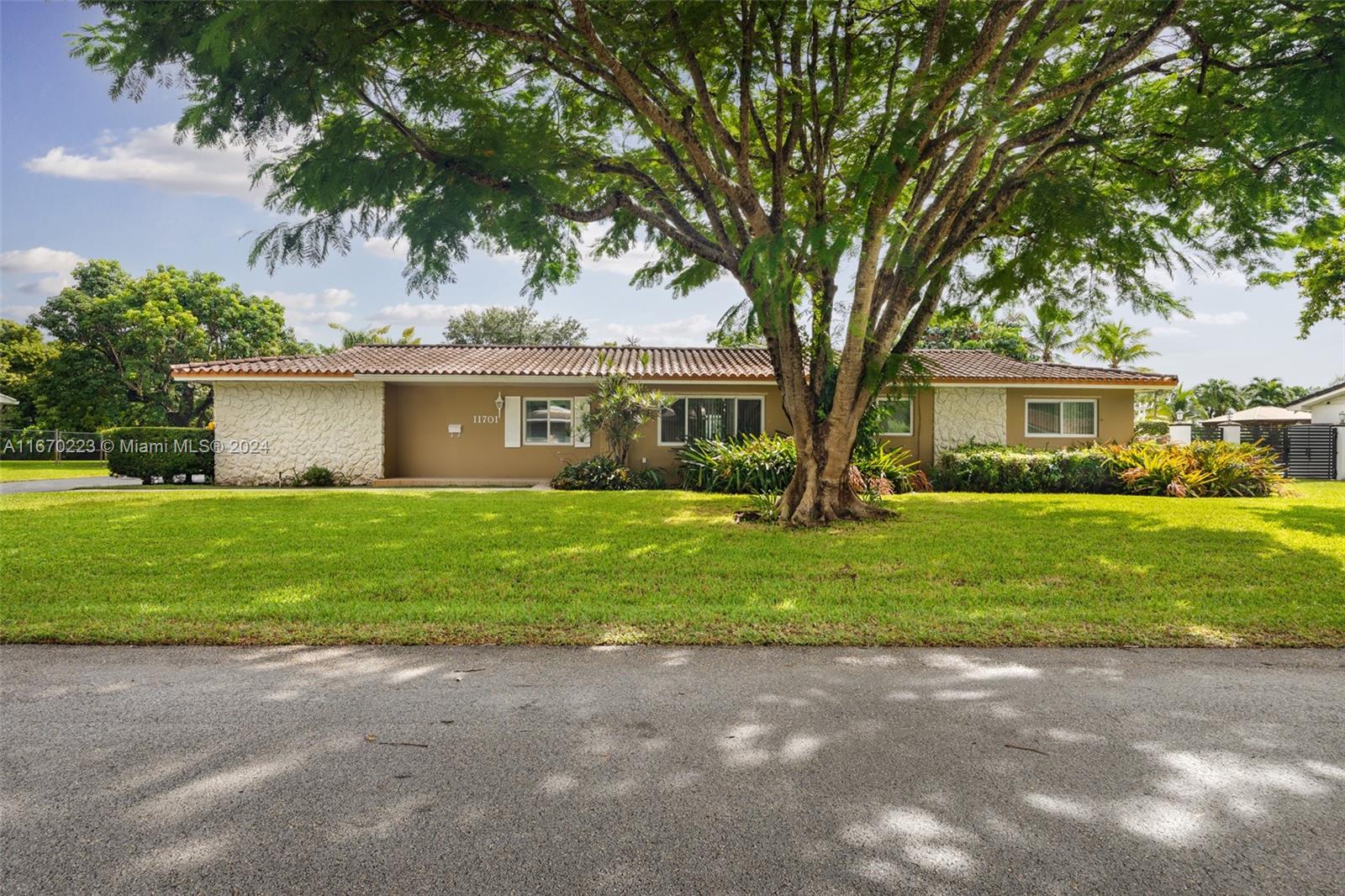 a front view of house with yard and green space