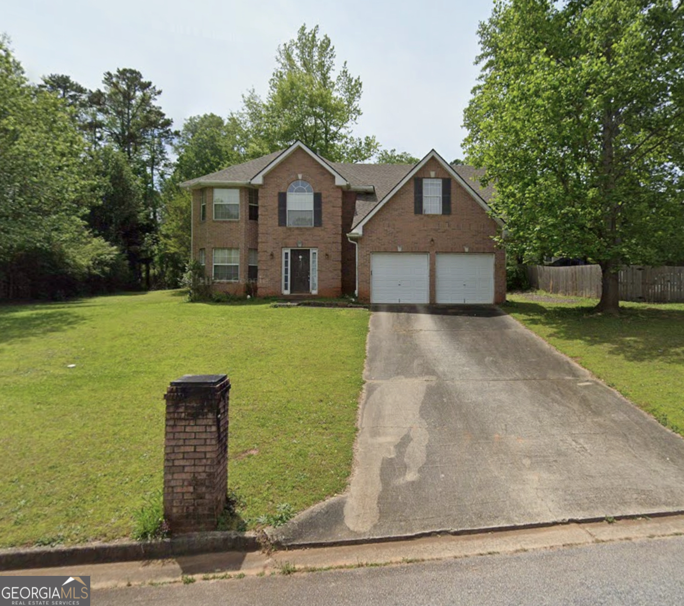 a front view of a house with yard