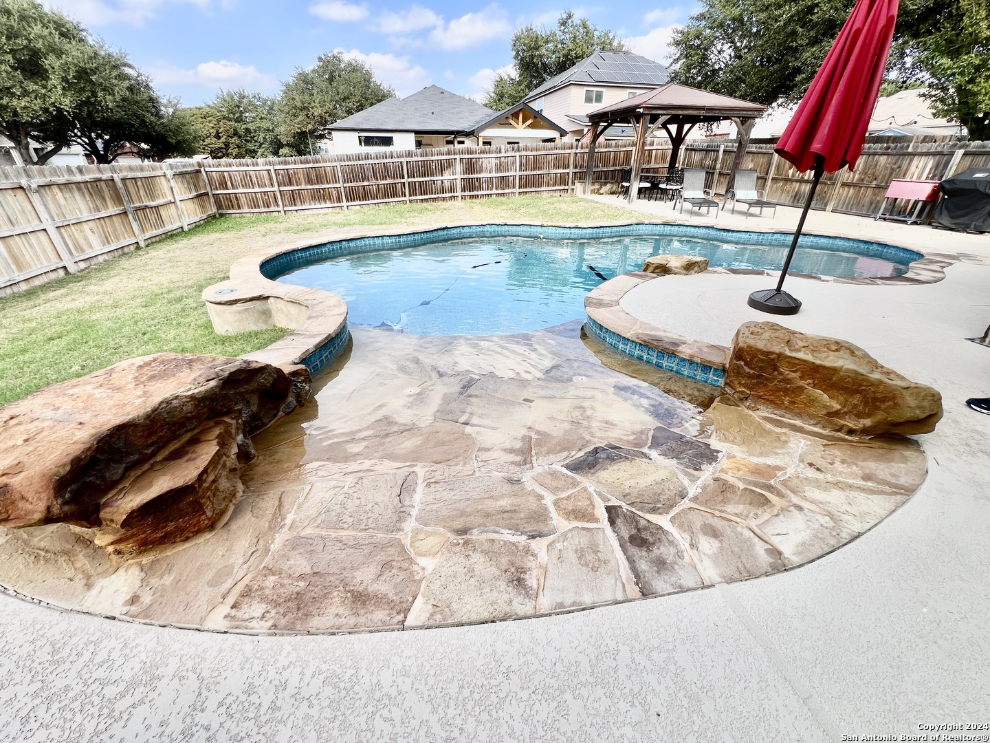 swimming pool view with a seating space