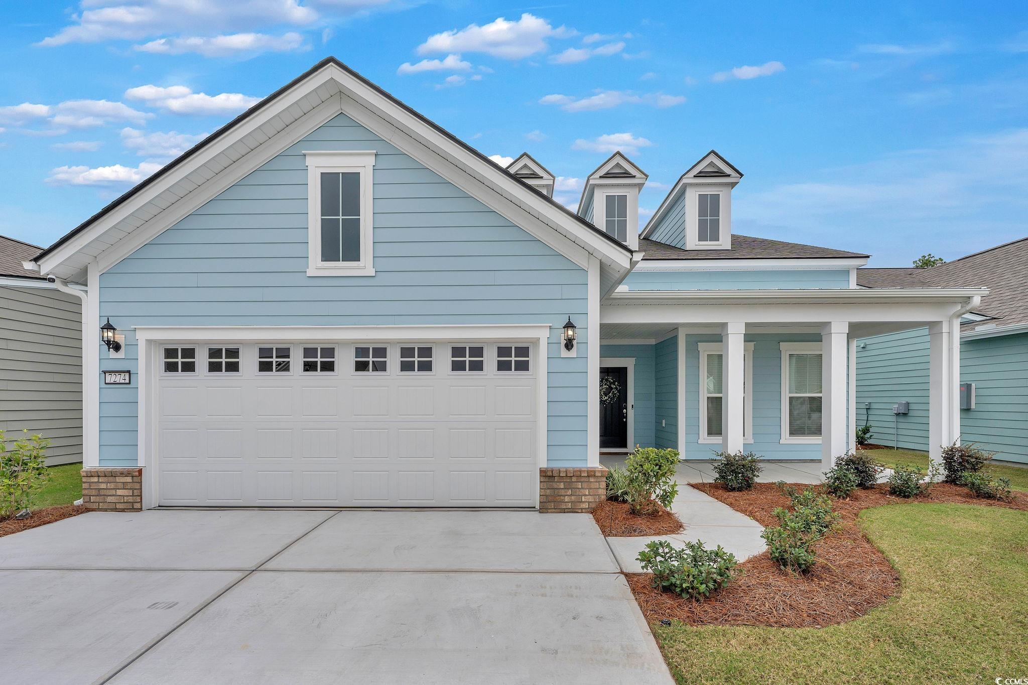 View of front of home featuring covered porch and