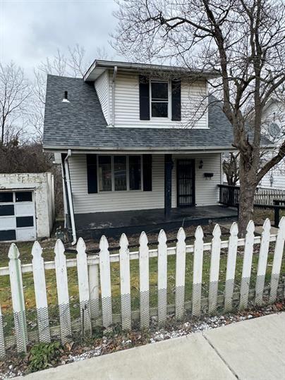 a front view of a house with wooden fence