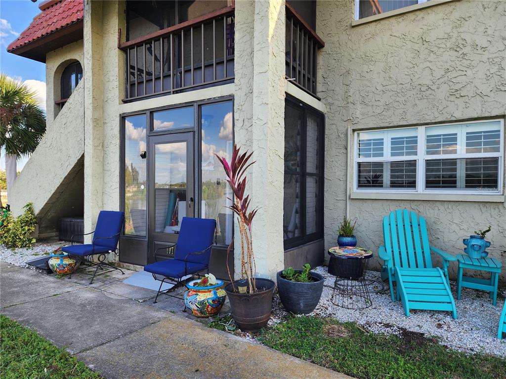 a front view of a house with outdoor seating and plants