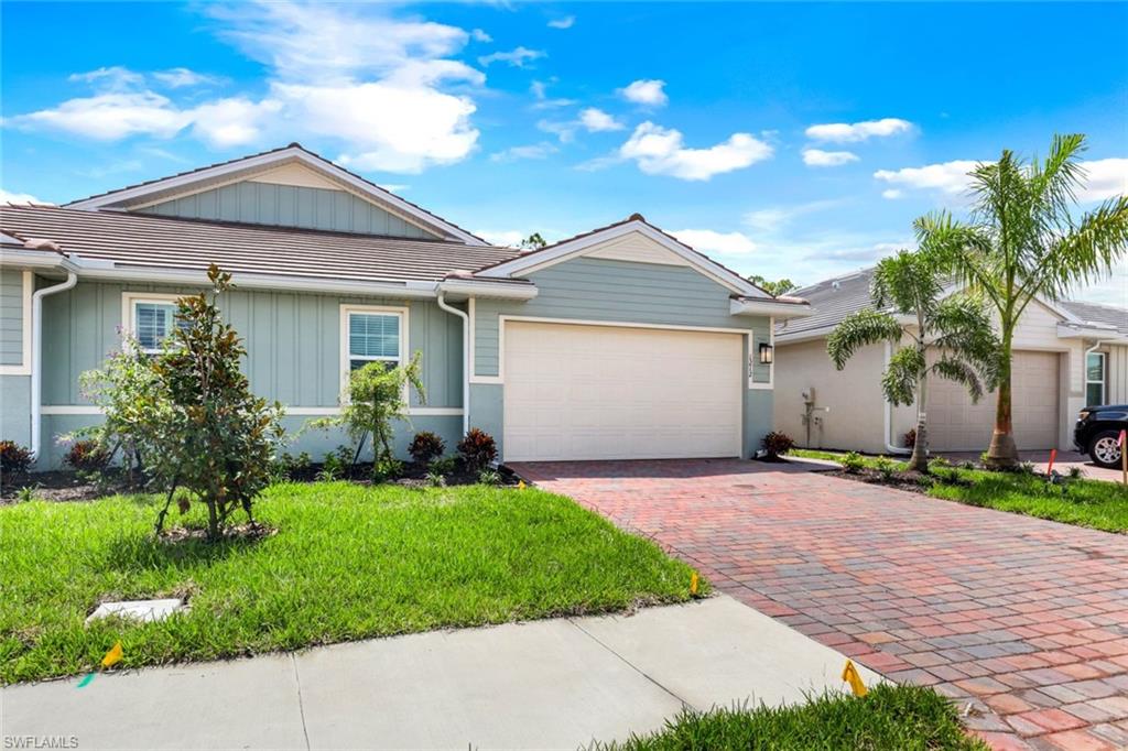 a front view of a house with a yard and garage