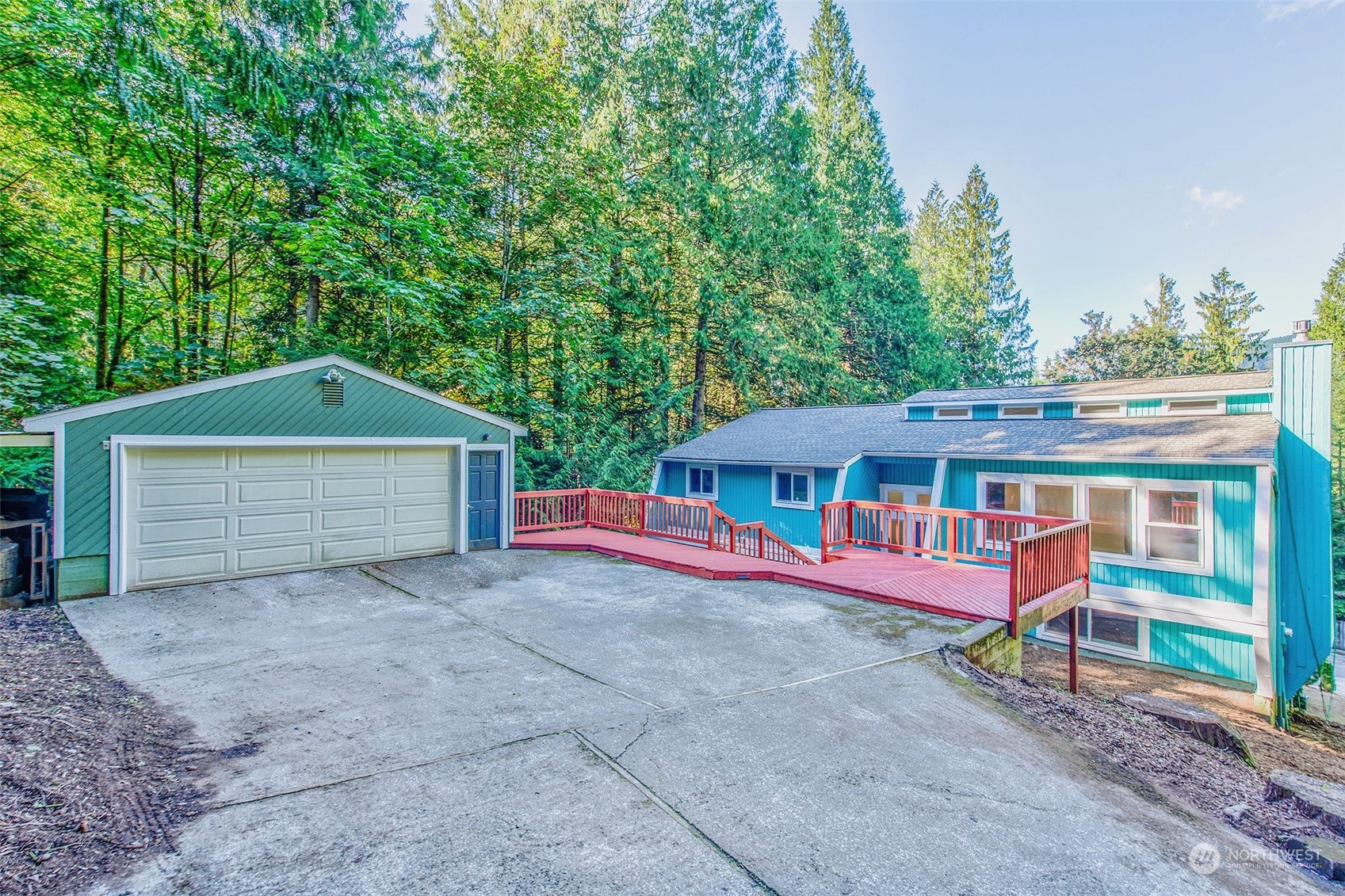 a view of a house with a yard and large tree