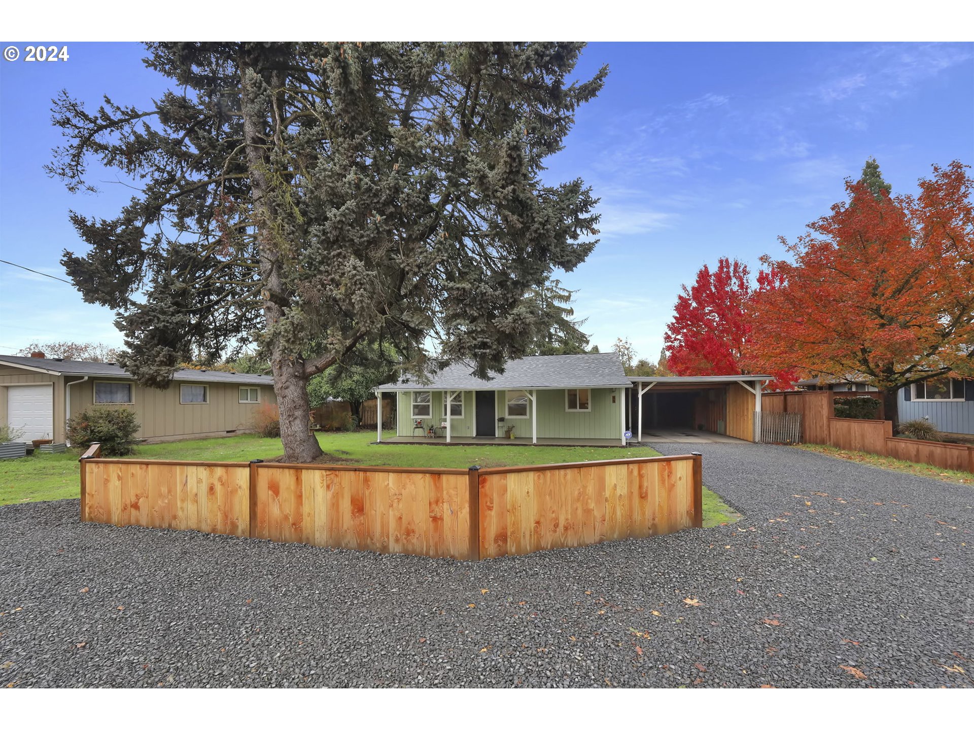 a view of a house with wooden fence