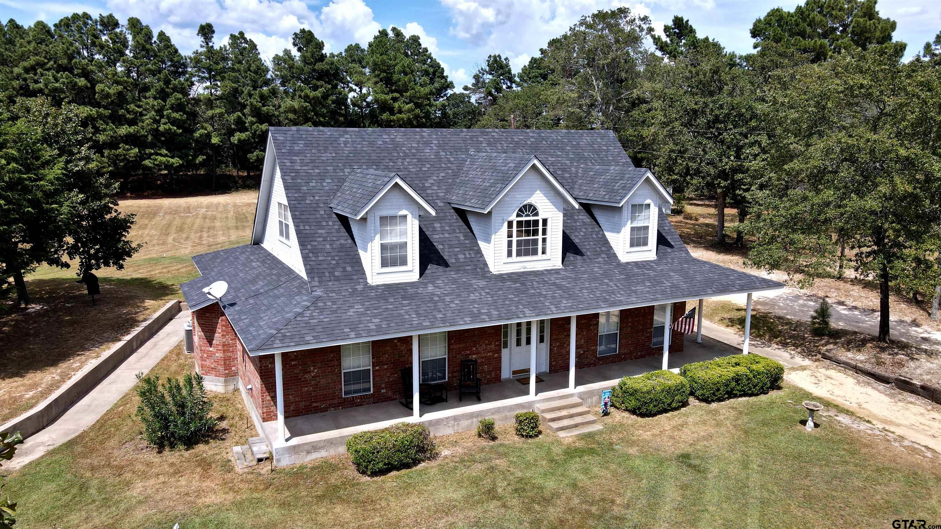 a aerial view of a house with a yard