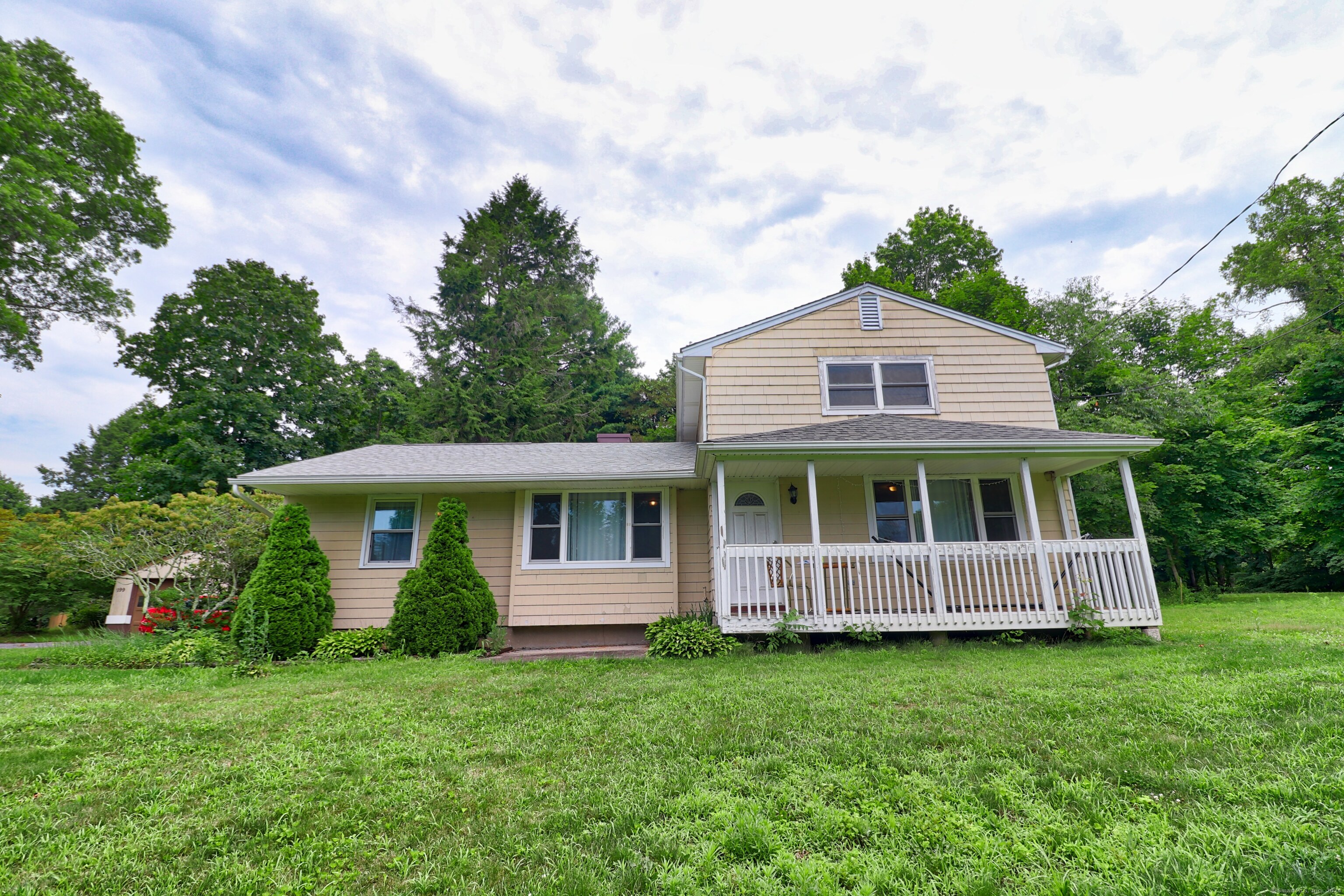 a front view of a house with a garden