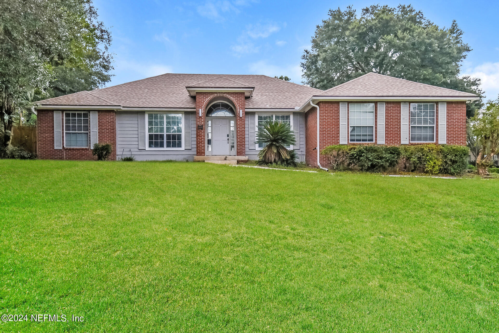 a front view of a house with a garden