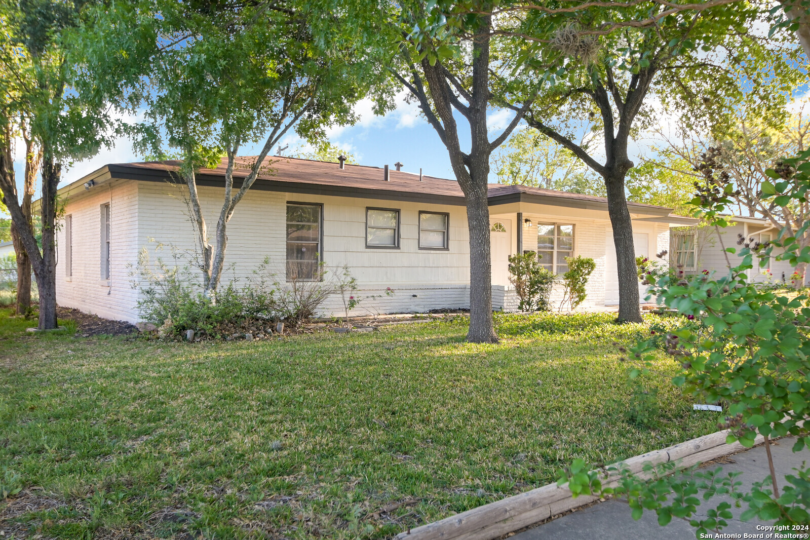 a front view of house with yard and green space