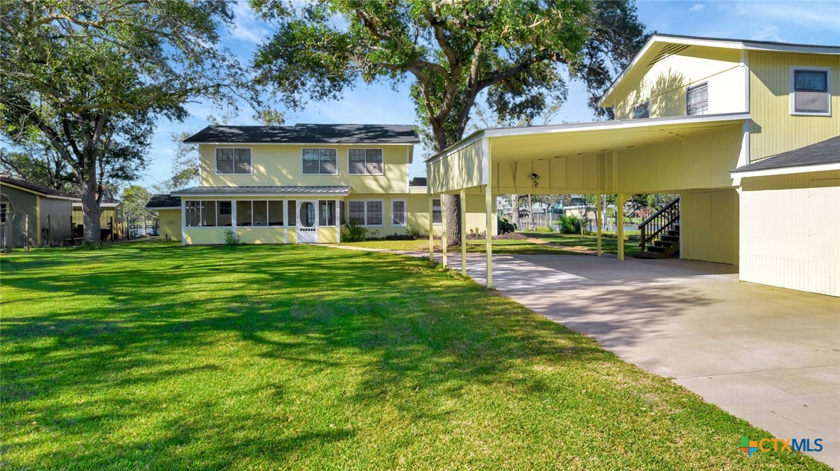 a front view of a house with a garden and trees