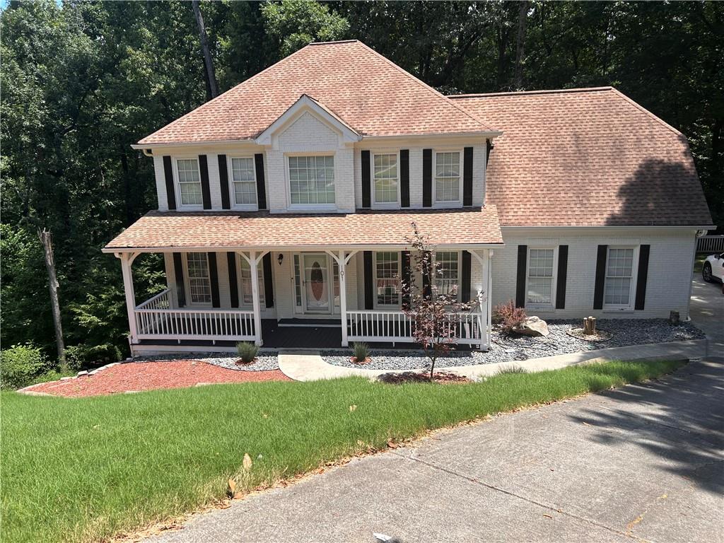 a front view of a house with garden and porch