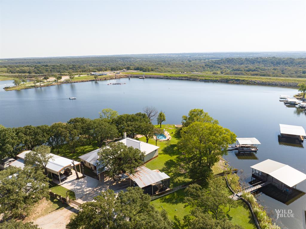 an aerial view of ocean with residential house with outdoor space