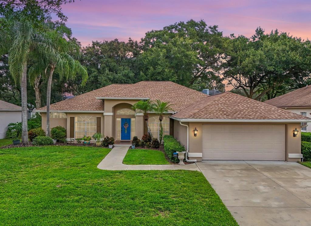 a front view of a house with a yard and garage