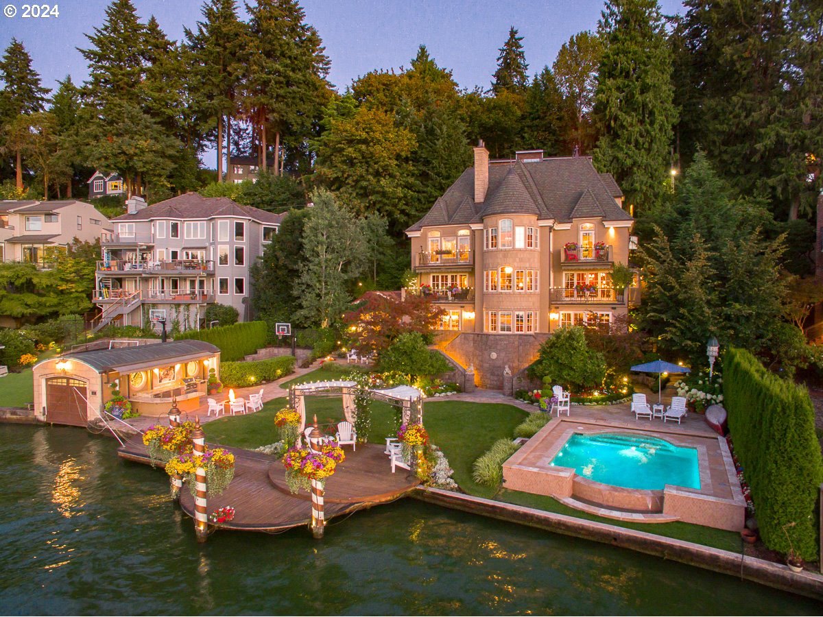 a aerial view of a house with swimming pool a yard and a patio