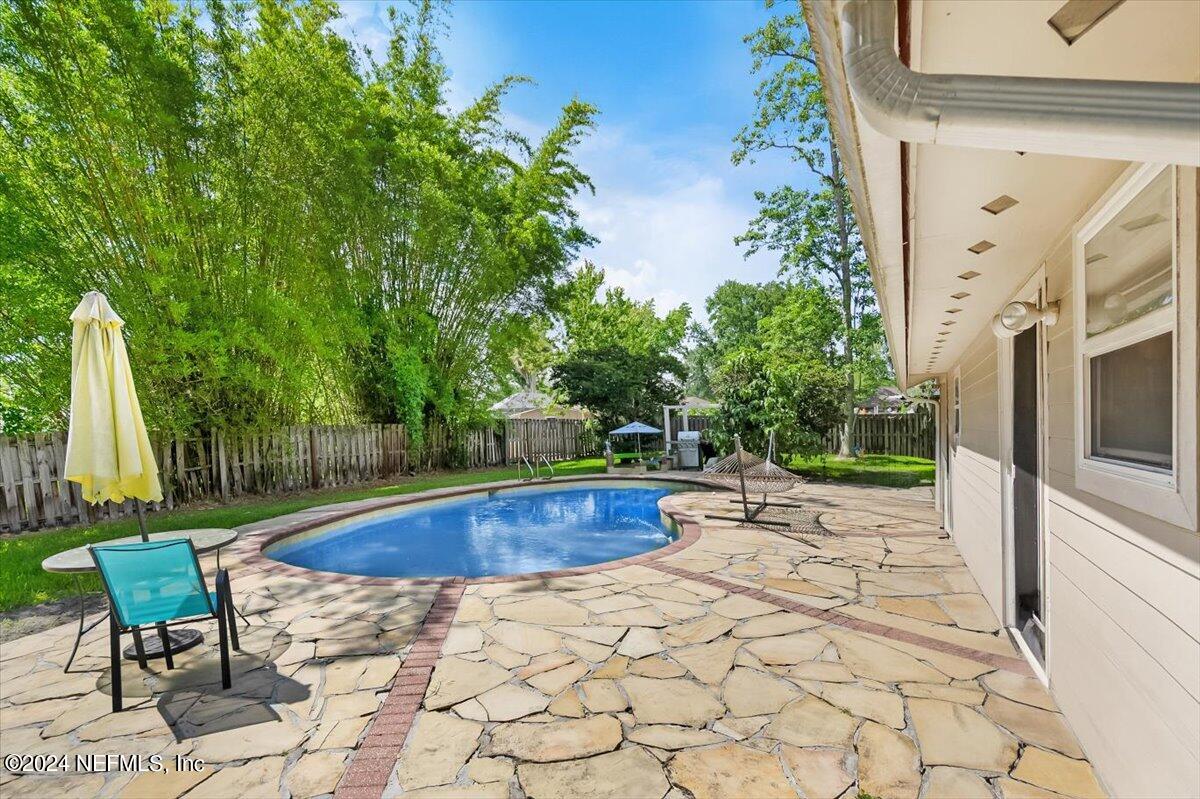 swimming pool view with a seating space