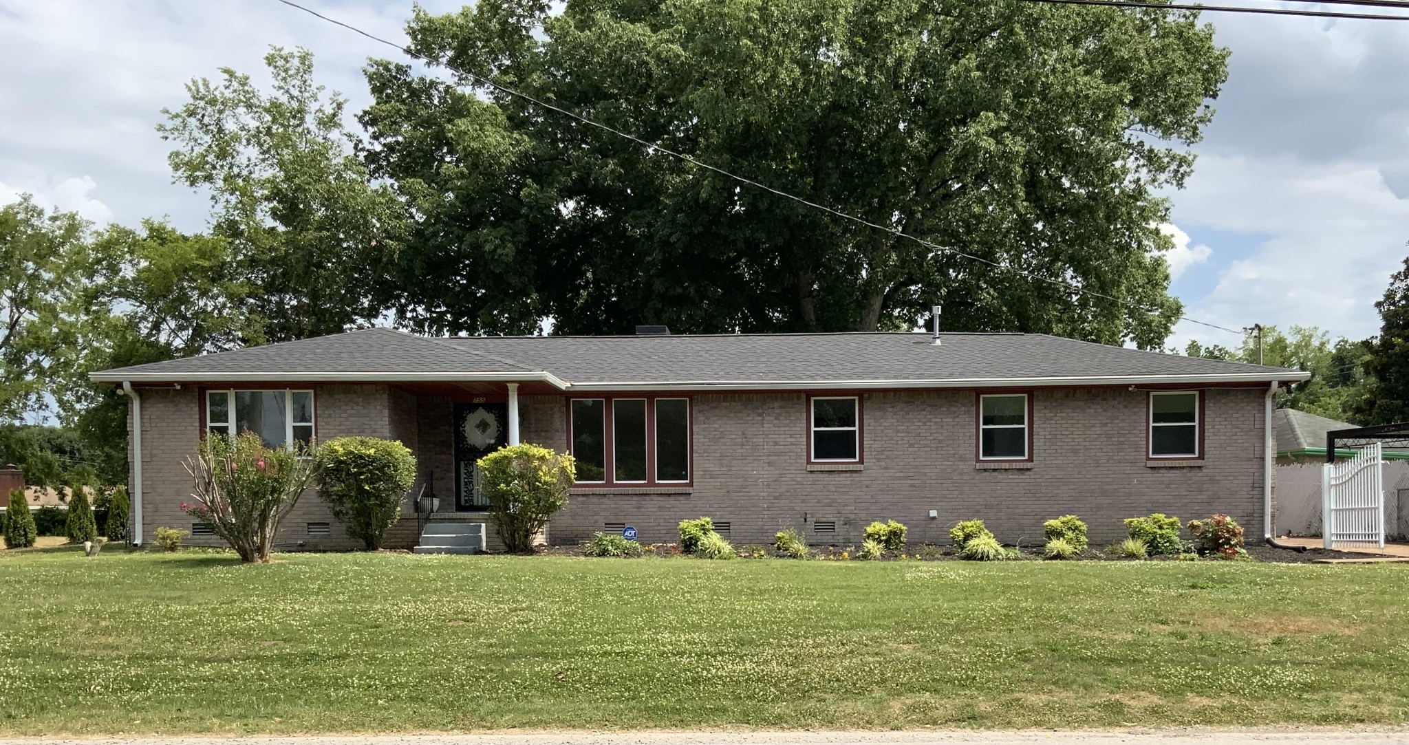 a front view of house with yard and green space