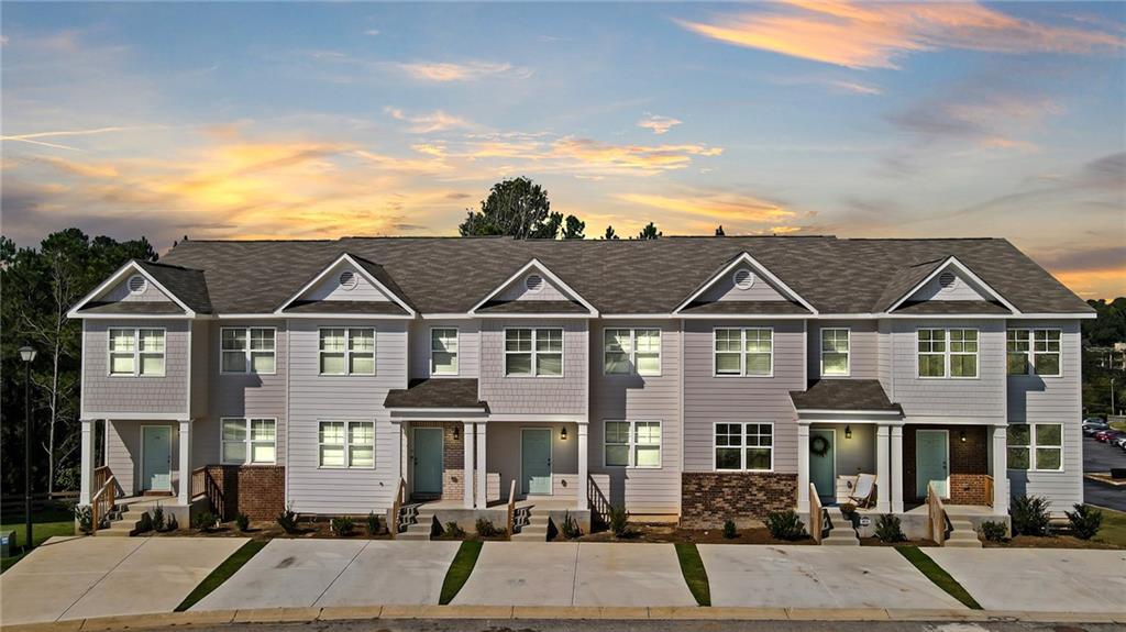 a front view of a residential apartment building with a yard