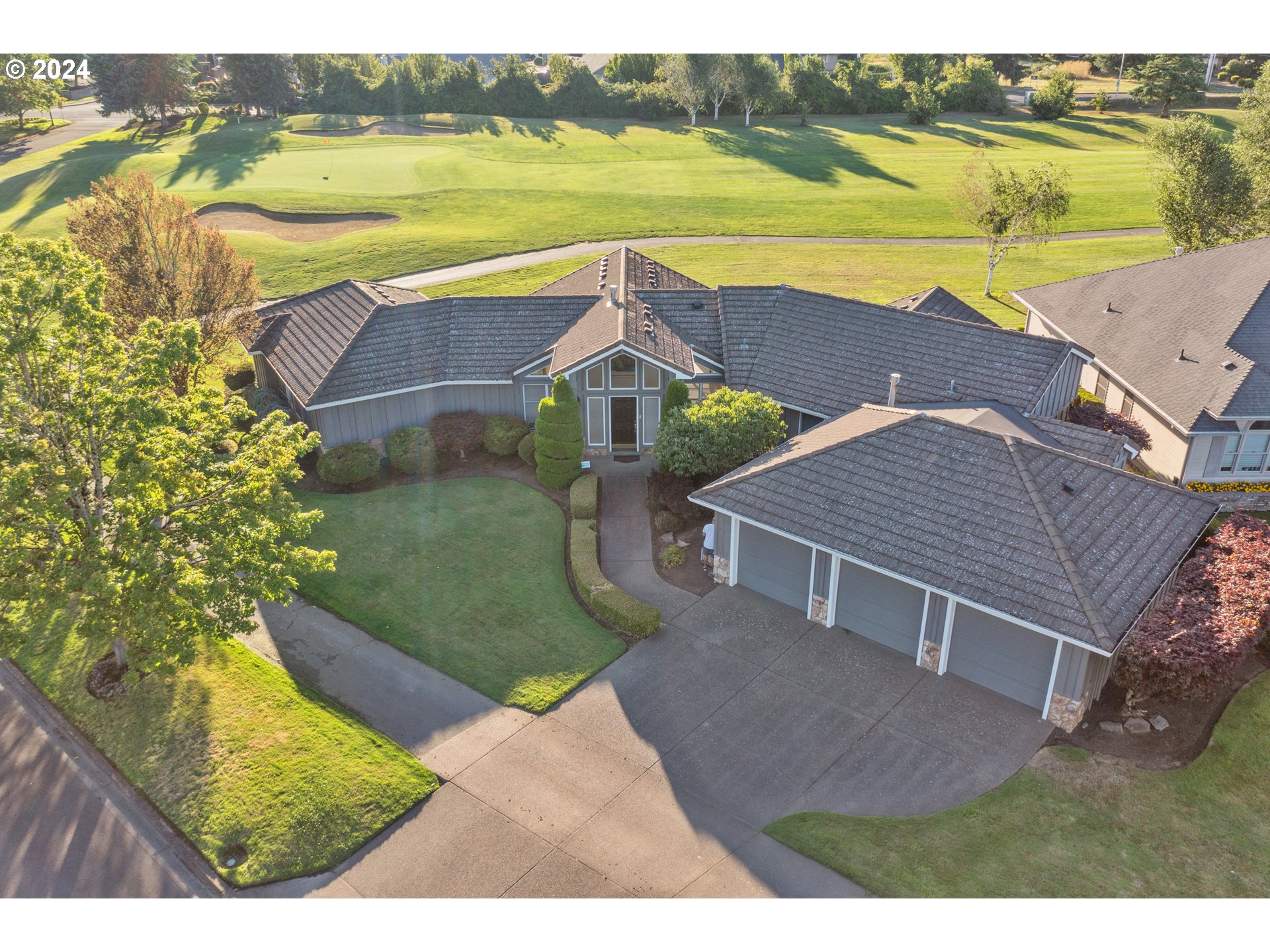 an aerial view of residential houses with outdoor space and ocean view