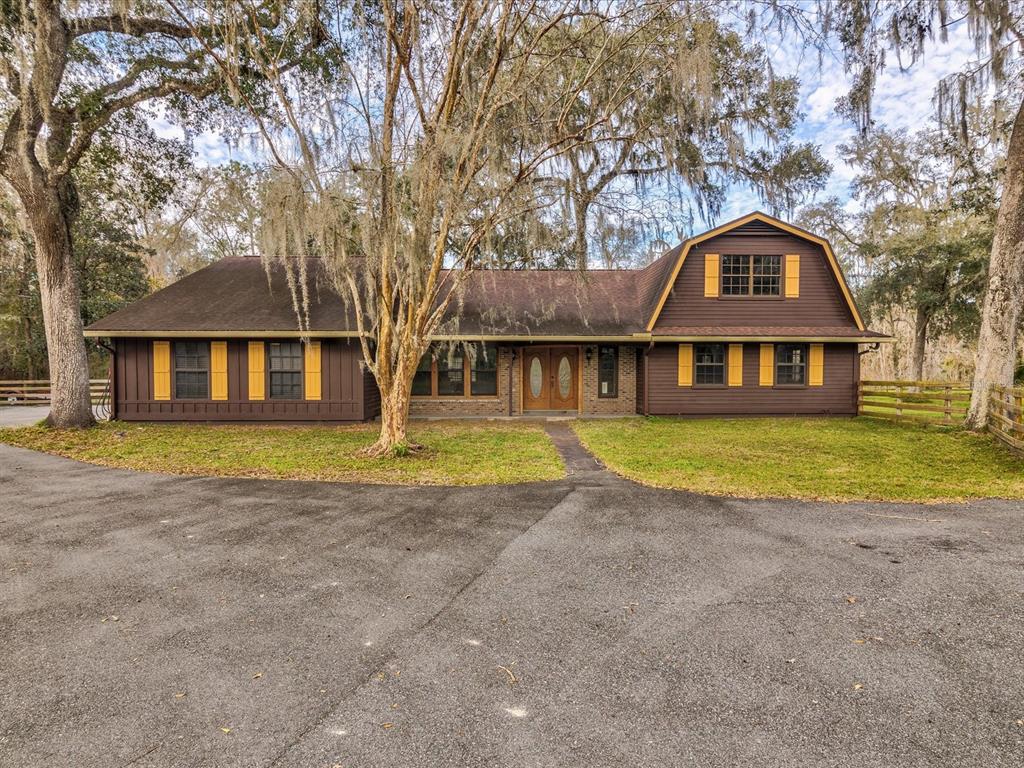 a view of a house with a backyard