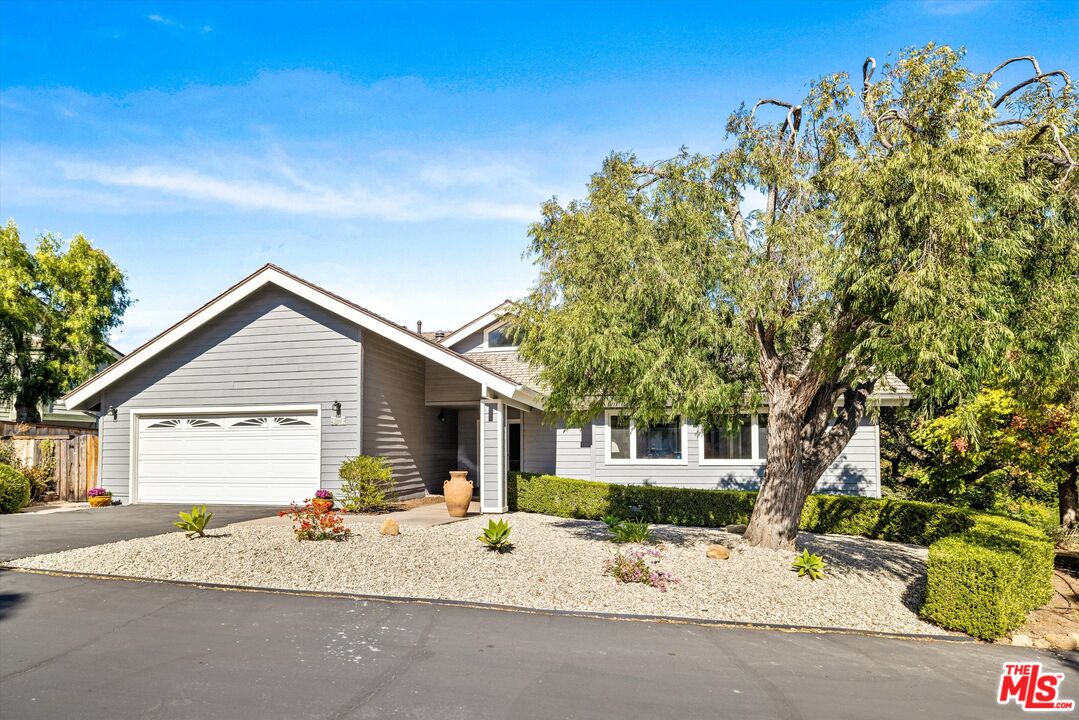 a view of a house with a tree and a yard