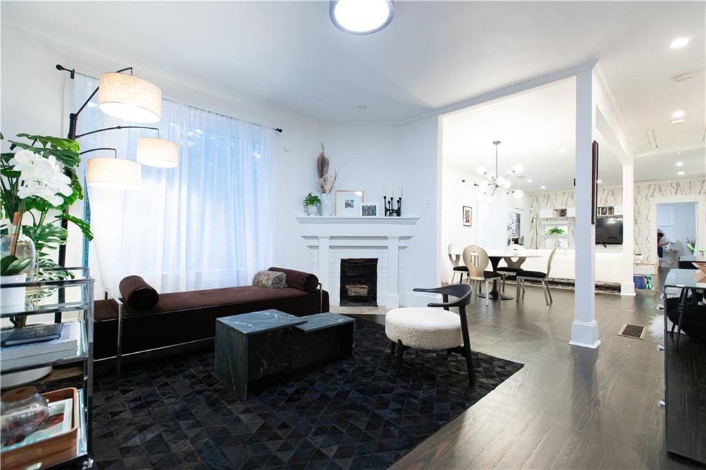 a living room with furniture fireplace and potted plant