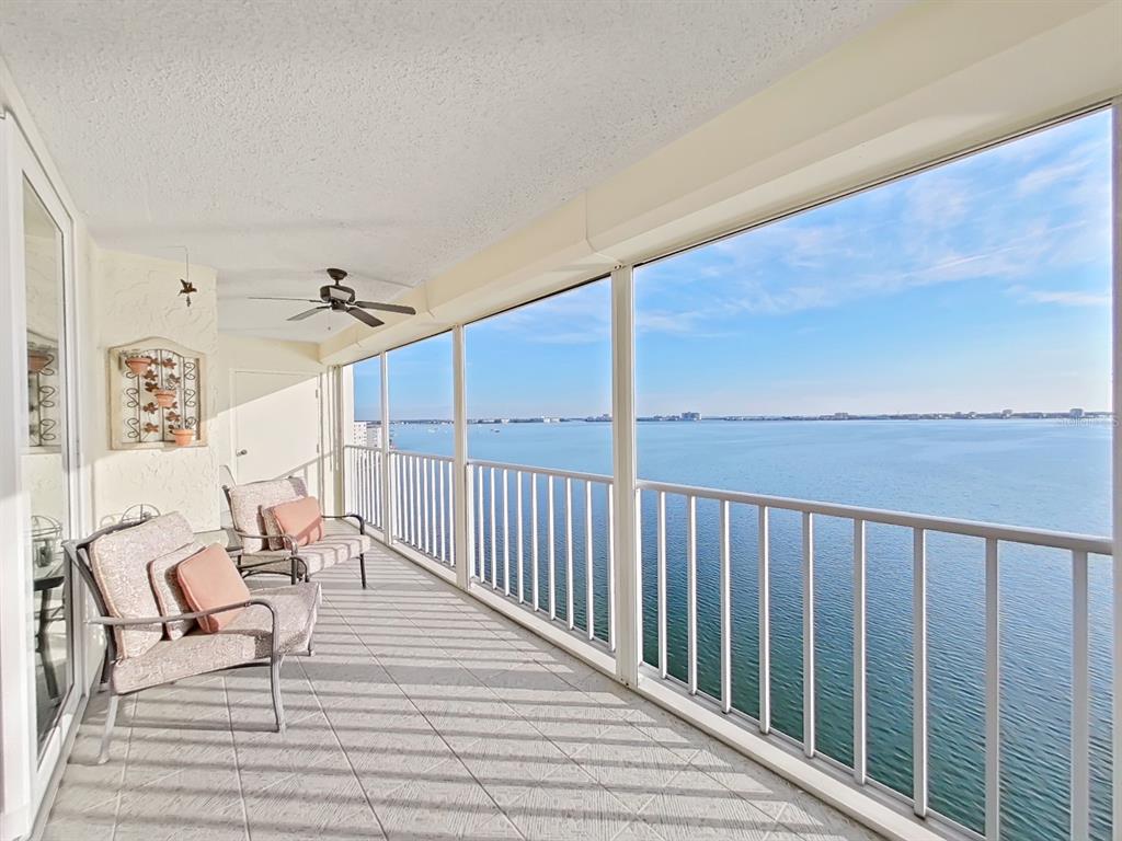 a balcony with chairs and wooden floor