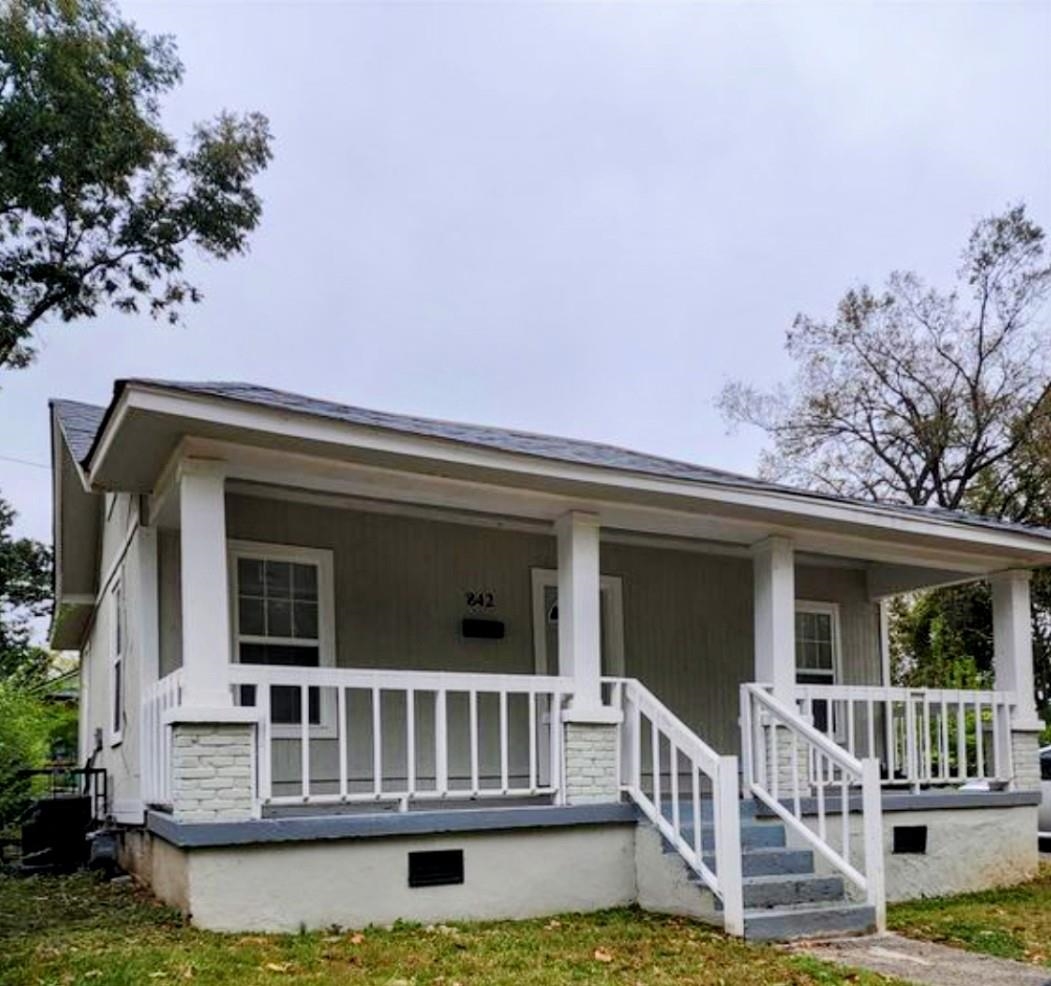 a view of house with a deck and furniture