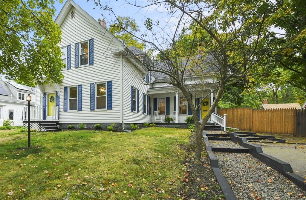 a view of a house with backyard sitting area and garden