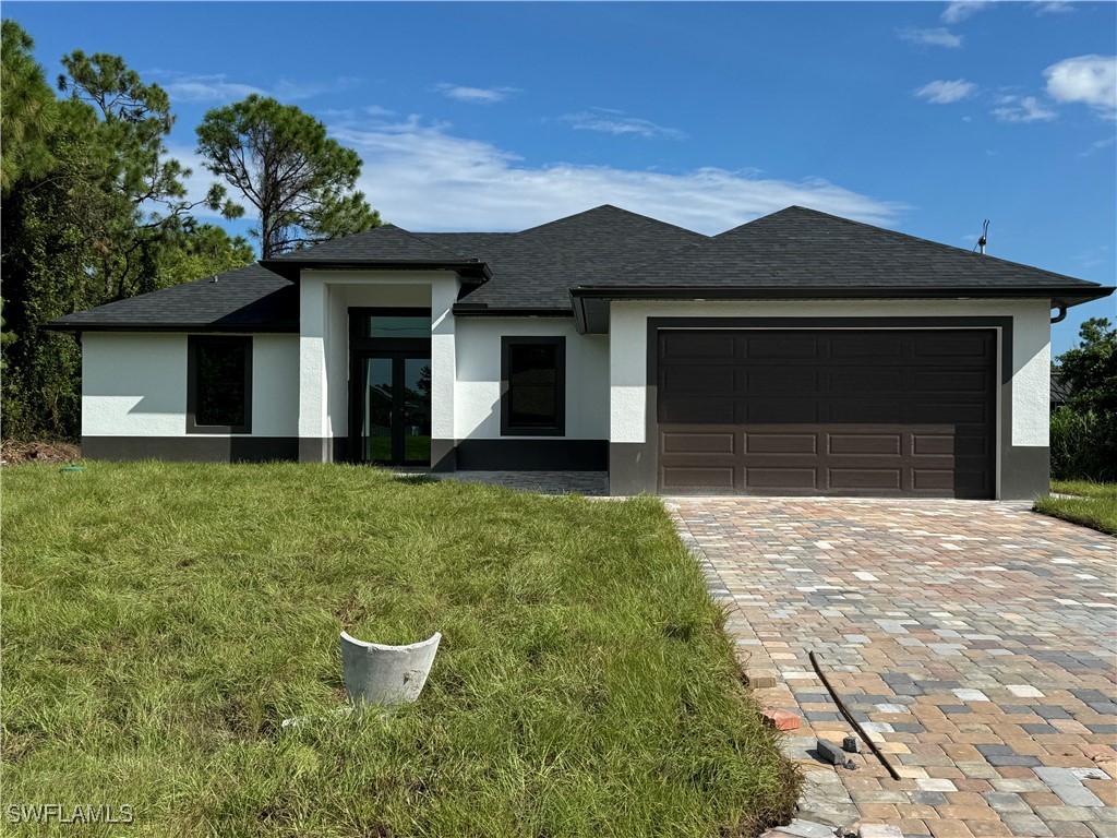 a front view of a house with a yard and garage