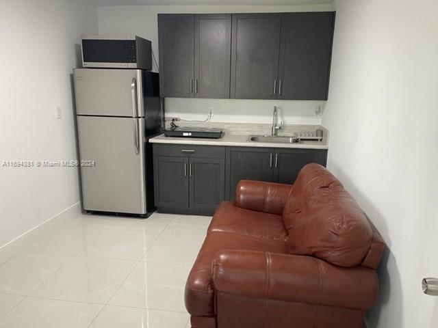 a kitchen with a refrigerator and a sink