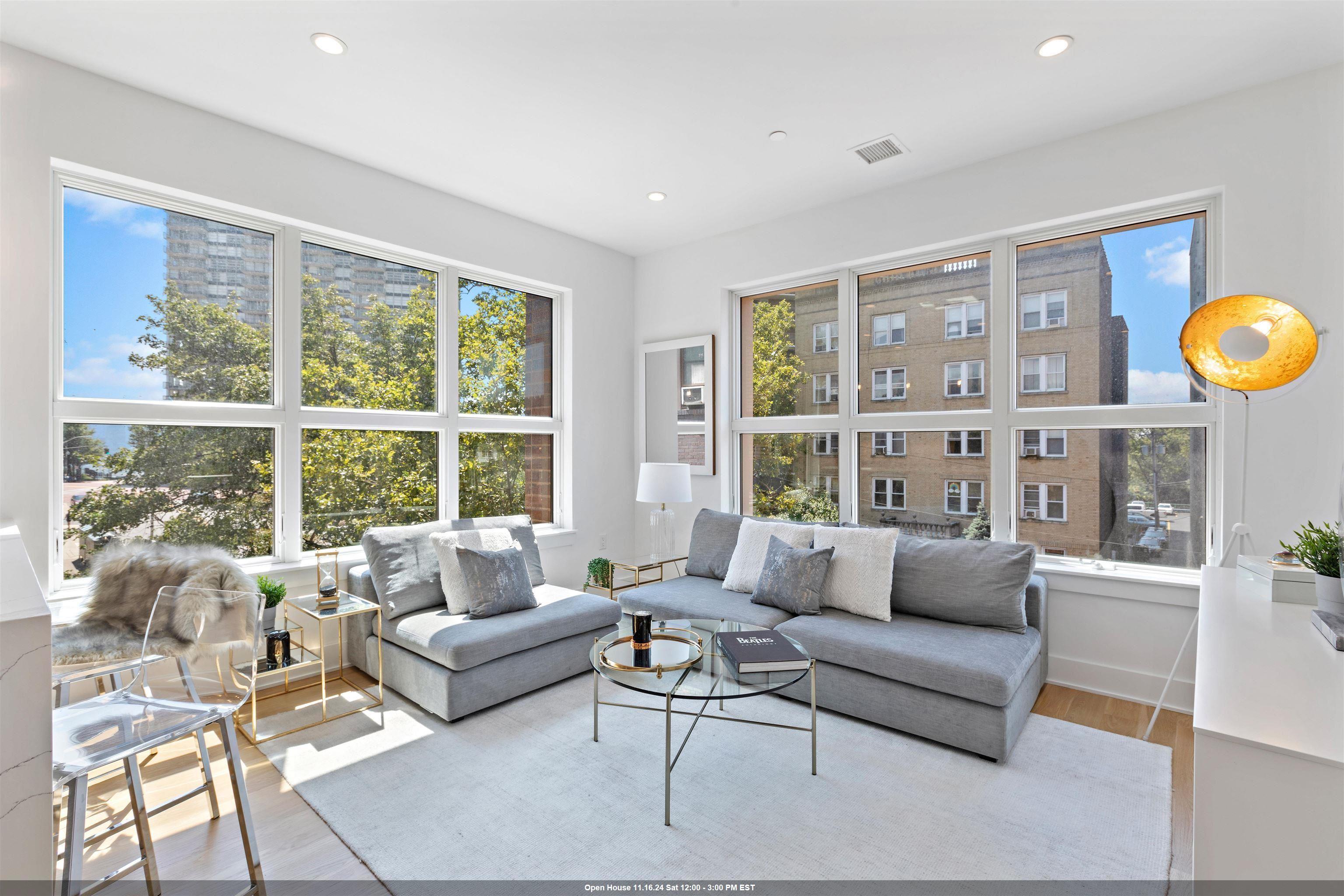 a living room with furniture and a large window