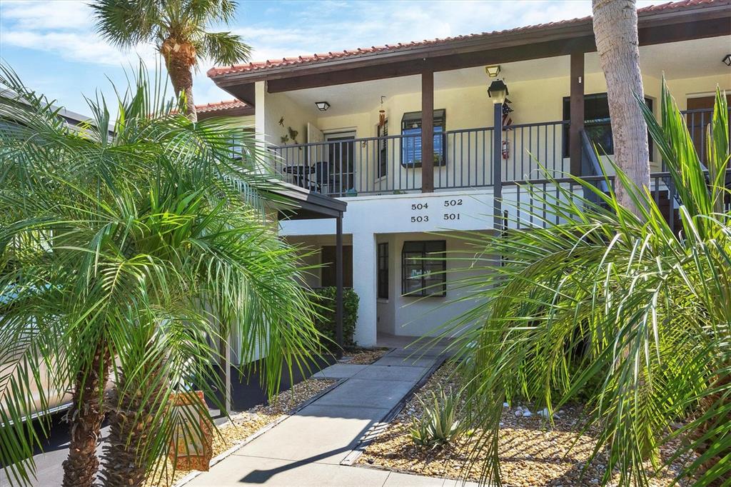 a front view of house along with deck and outdoor seating