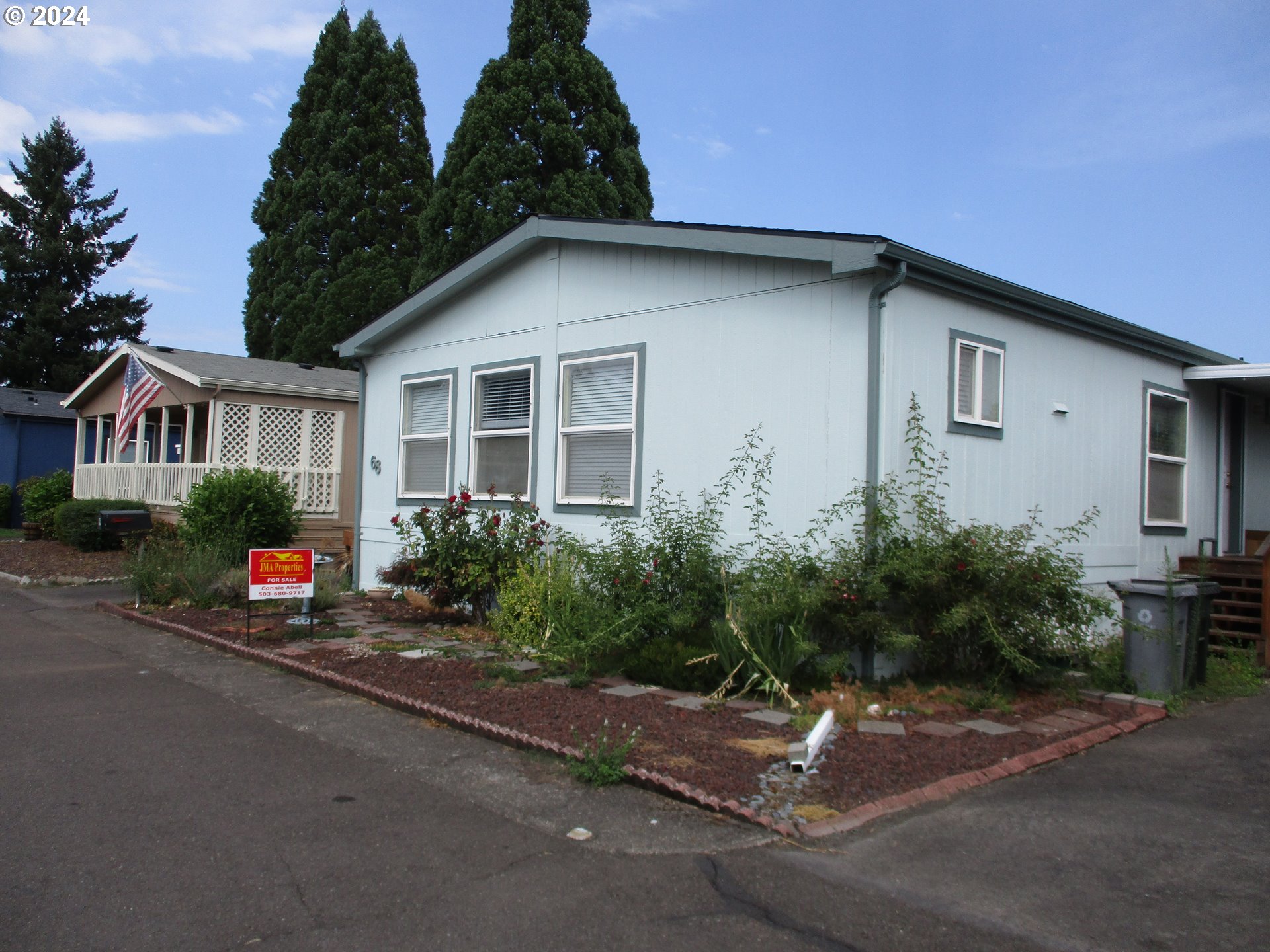 a backyard of a house with plants and trees