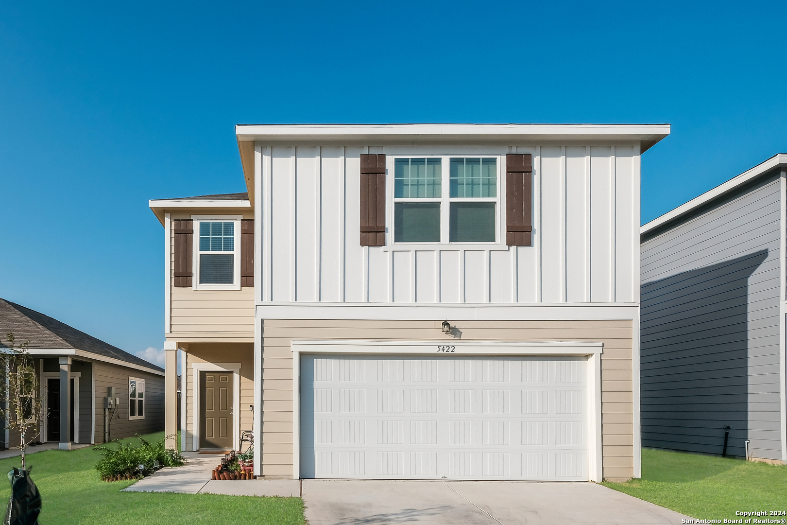 a front view of a house with a yard