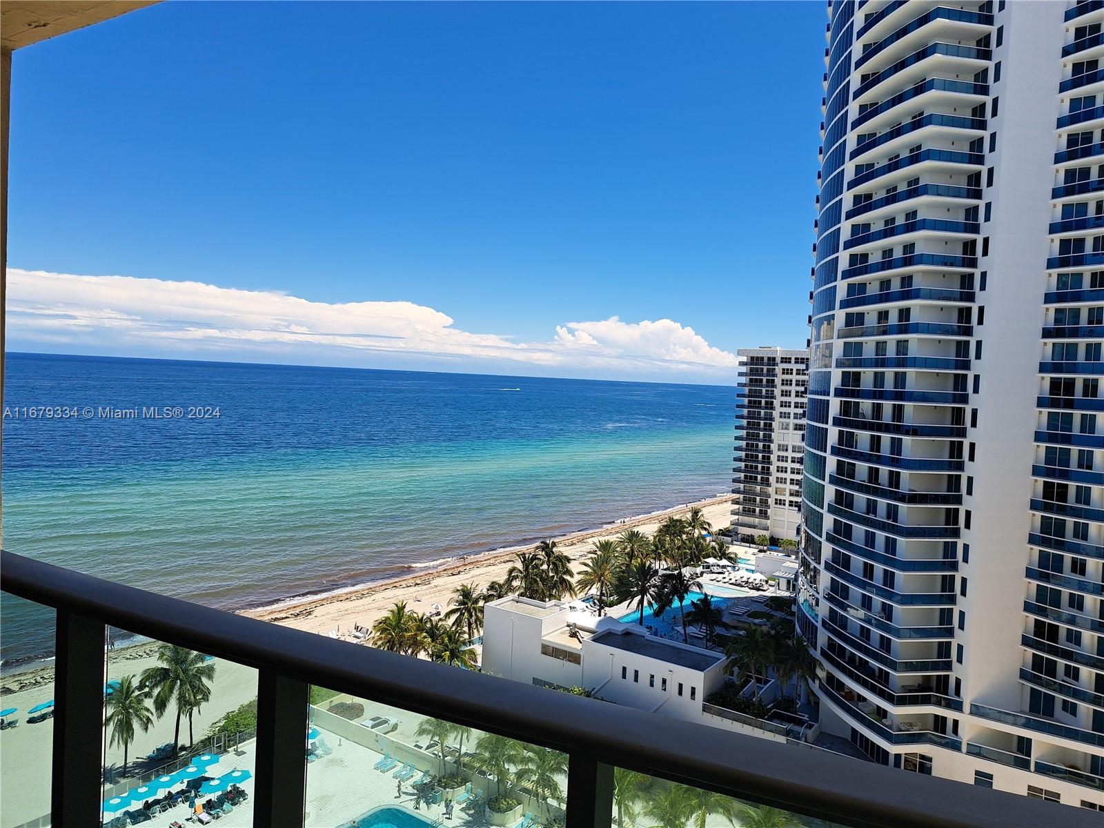 a view of a balcony next to a yard