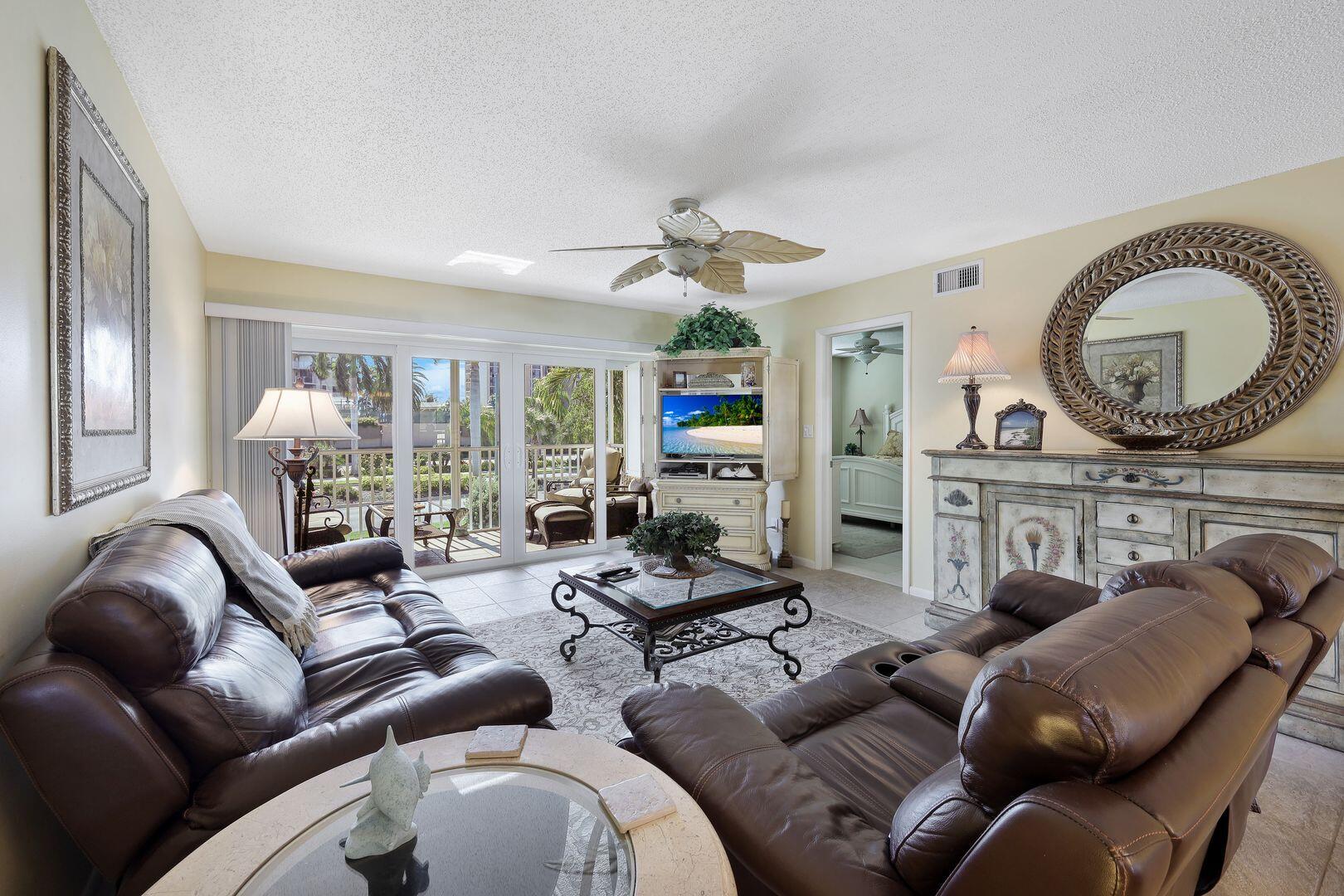 a living room with furniture a large window and a fireplace